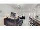 Open living space with marble floors, comfortable seating, and a modern fireplace at 21668 Sw Peach Blossom St, Dunnellon, FL 34431