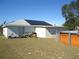 Backyard view showcasing solar panels, pool, and screened porch at 221 Locust Ln, Ocala, FL 34472