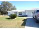 Front yard view of house with truck parked in driveway at 221 Locust Ln, Ocala, FL 34472