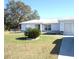 House exterior with driveway, landscaping and a carport at 221 Locust Ln, Ocala, FL 34472