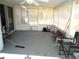 Enclosed porch with ceiling fan, storage, and seating at 221 Locust Ln, Ocala, FL 34472