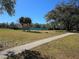 Community tennis court with surrounding grassy area at 2424 Sw 20Th Ct, Ocala, FL 34471