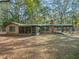 Rustic ranch house with screened porch and covered carport at 3041 S Us Highway 41, Dunnellon, FL 34432