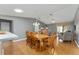 Bright dining area with wood table and chairs, open to kitchen and living room at 3324 Oakdale Pl, The Villages, FL 32162