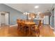 Dining area with wood table and chairs, open to kitchen and living room at 3324 Oakdale Pl, The Villages, FL 32162