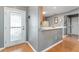 Bright entryway with kitchen view and wood flooring at 3324 Oakdale Pl, The Villages, FL 32162