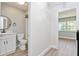 Bathroom with white vanity, toilet and view of bedroom at 4343 Nw 80Th Ave # 4, Ocala, FL 34482