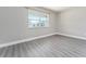 Bright bedroom with grey laminate flooring and large window at 4343 Nw 80Th Ave # 4, Ocala, FL 34482