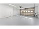 Attached garage with light grey epoxy floor and overhead door at 4343 Nw 80Th Ave # 4, Ocala, FL 34482