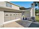 Rear view of house showing garage with screen doors and AC unit at 4343 Nw 80Th Ave # 4, Ocala, FL 34482