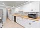 Modern kitchen with white cabinets, butcher block countertops and tile backsplash at 4343 Nw 80Th Ave # 4, Ocala, FL 34482