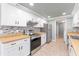 Modern kitchen with white cabinets, butcher block countertops and tile backsplash at 4343 Nw 80Th Ave # 4, Ocala, FL 34482