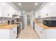 Modern kitchen with white cabinets, butcher block countertops and tile backsplash at 4343 Nw 80Th Ave # 4, Ocala, FL 34482