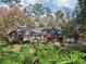 Sprawling backyard featuring lush greenery, creating a serene and private outdoor space at 4400 Sw 20Th Ave, Ocala, FL 34471