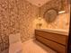 Stylish bathroom featuring modern vanity, pendant lighting, and patterned wallpaper at 4400 Sw 20Th Ave, Ocala, FL 34471