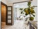 Bathroom featuring a soaking tub, glass shower, marble floors, and ample natural light at 4400 Sw 20Th Ave, Ocala, FL 34471