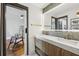 Double vanity bathroom with marble countertops and a modern mirror at 4400 Sw 20Th Ave, Ocala, FL 34471