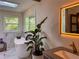 Serene bathroom featuring a soaking tub, natural light, and modern vanity with sleek fixtures at 4400 Sw 20Th Ave, Ocala, FL 34471