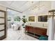 Luxurious bathroom with a freestanding tub, marble floors, double vanity, and modern lighting at 4400 Sw 20Th Ave, Ocala, FL 34471