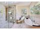 Bright bathroom showcasing a modern shower, soaking tub, and marble flooring at 4400 Sw 20Th Ave, Ocala, FL 34471