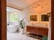 Elegant bathroom with soaking tub, illuminated mirrors, and modern vanity at 4400 Sw 20Th Ave, Ocala, FL 34471