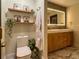 Charming bathroom with wooden accents and shelving, and a decorative mirror at 4400 Sw 20Th Ave, Ocala, FL 34471