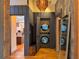 Hallway features stacked laundry machines and access to other rooms, showcasing modern living at 4400 Sw 20Th Ave, Ocala, FL 34471