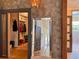 Hallway with mirror, leading to closet with built-ins and a glimpse of the bathroom at 4400 Sw 20Th Ave, Ocala, FL 34471