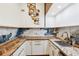 The kitchen features custom countertops and backsplash, white cabinets with gold hardware, and a unique art piece at 4400 Sw 20Th Ave, Ocala, FL 34471