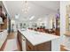 Modern kitchen featuring a large island with quartz countertops, hardwood floors, and stainless steel appliances at 4400 Sw 20Th Ave, Ocala, FL 34471
