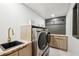 Well-equipped laundry room with modern appliances, a sink, and ample counter space at 4400 Sw 20Th Ave, Ocala, FL 34471