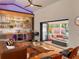 Inviting living room featuring a custom bar, hardwood floors and an indoor/outdoor flow to a covered patio with fire pit at 4400 Sw 20Th Ave, Ocala, FL 34471
