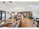 Open-concept living room featuring a stylish kitchen, skylights, hardwood floors, and modern furnishings at 4400 Sw 20Th Ave, Ocala, FL 34471