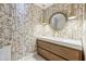 Modern powder room featuring stylish wallpaper, pendant lighting, and a wood vanity at 4400 Sw 20Th Ave, Ocala, FL 34471