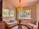 Cozy sitting area with decorative lighting, plush seating, and serene views from large windows at 4400 Sw 20Th Ave, Ocala, FL 34471