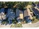 Aerial view of a neighborhood home with a landscaped front yard, driveway, and well-maintained roof at 4542 Ne 4Th St, Ocala, FL 34470