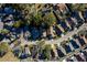 Aerial neighborhood shot of a cluster of homes featuring neatly arranged streets and verdant trees and shrubbery at 4542 Ne 4Th St, Ocala, FL 34470