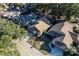 Aerial view showcasing a home's roof, landscaping, driveway, and surrounding neighborhood streets and trees at 4542 Ne 4Th St, Ocala, FL 34470