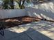 A fully fenced backyard features a concrete patio and mulch flower bed at 4542 Ne 4Th St, Ocala, FL 34470