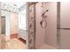 Bathroom with floral wallpaper, a sink with granite countertops, and a tiled walk-in shower at 4542 Ne 4Th St, Ocala, FL 34470