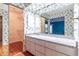 Bathroom features a granite countertop, floral wallpaper, and a well-organized walk-in closet at 4542 Ne 4Th St, Ocala, FL 34470