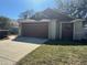 Single-story home featuring a spacious two-car garage and well-manicured lawn, creating a welcoming exterior at 4542 Ne 4Th St, Ocala, FL 34470