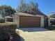 A charming single-story home features a two-car garage and mature landscaping at 4542 Ne 4Th St, Ocala, FL 34470