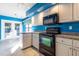 Modern kitchen with black appliances and granite counters at 4542 Ne 4Th St, Ocala, FL 34470