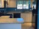 Galley kitchen boasts granite countertops, sleek black appliances and bright white cabinets at 4542 Ne 4Th St, Ocala, FL 34470