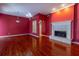 Bright living room with a fireplace, wood floors, and a decorative chandelier at 4542 Ne 4Th St, Ocala, FL 34470