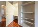 Small home office with built-in shelving and wood floors at 4542 Ne 4Th St, Ocala, FL 34470