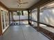 Enclosed patio offering an outdoor relaxation space with screened windows and a ceiling fan at 4542 Ne 4Th St, Ocala, FL 34470