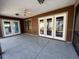 Covered back patio with multiple access doors and ceiling fan providing a perfect space for outdoor relaxation at 4542 Ne 4Th St, Ocala, FL 34470