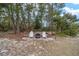 Relaxing backyard firepit area with two white Adirondack chairs at 4585 Sw 112Th Ln, Ocala, FL 34476